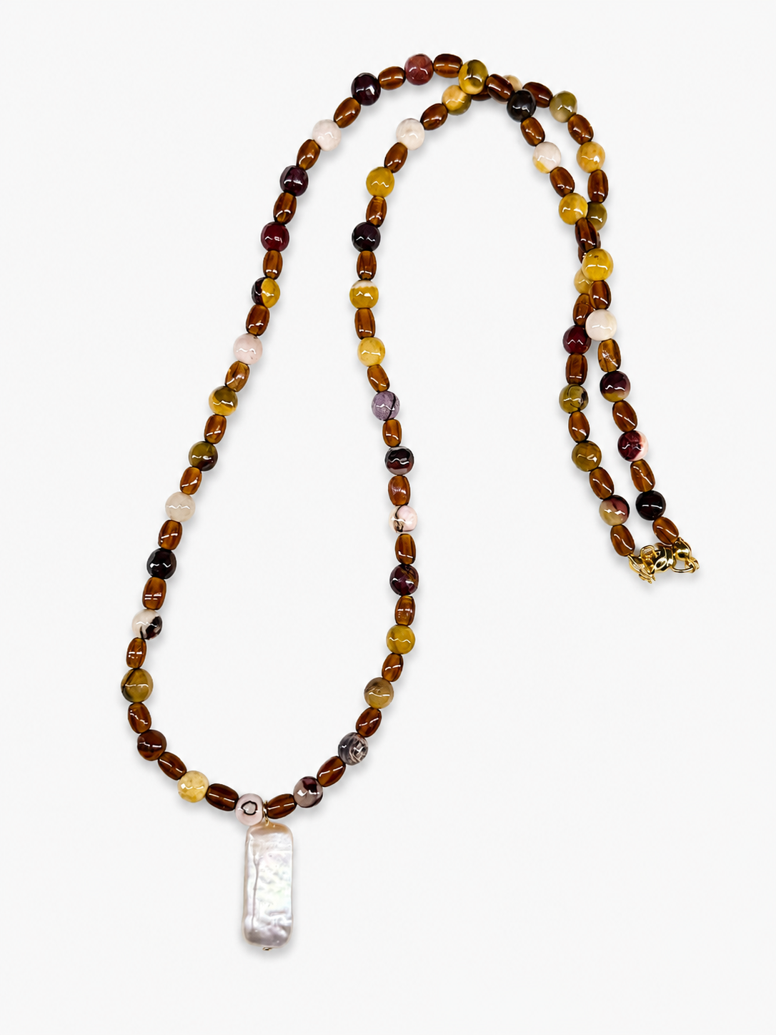 Mookite jasper bead necklace in warm earth tones with a rectangular freshwater pearl pendant and gold clasp.