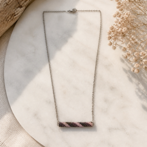 Minimal sterling silver necklace with slim beadwoven tube pendant in soft pink, lavender, and bronze tones.