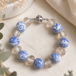 Chunky bracelet featuring marbled cobalt blue round beads paired with translucent quartz-like beads and a silver magnetic clasp.