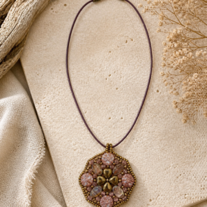 Floral-inspired pendant necklace with pink Czech glass beads, bronze accents, and geometric beaded medallion.
