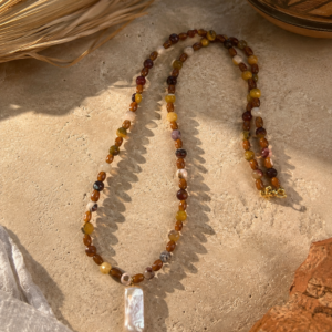 Mookite jasper bead necklace in warm earth tones with a rectangular freshwater pearl pendant and gold clasp.