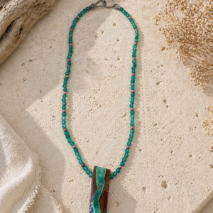 Minimal green beaded necklace with sterling silver accents and earthy geometric pendant centerpiece.