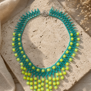 Statement fringe necklace in turquoise seed beads with bright yellow bead drops and coral-inspired openwork design.