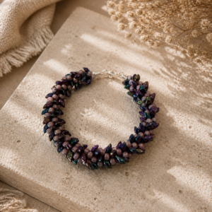 Textured bracelet with iridescent purple dagger beads and soft lavender round beads in clustered floral pattern.