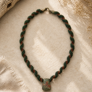 Twisted beadwoven rope necklace in deep green and copper with polished jasper stone pendant centerpiece.
