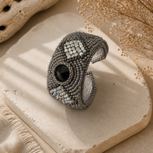 Gunmetal bead embroidered cuff bracelet with black crystal centerpiece and shimmering silver crystal accents.