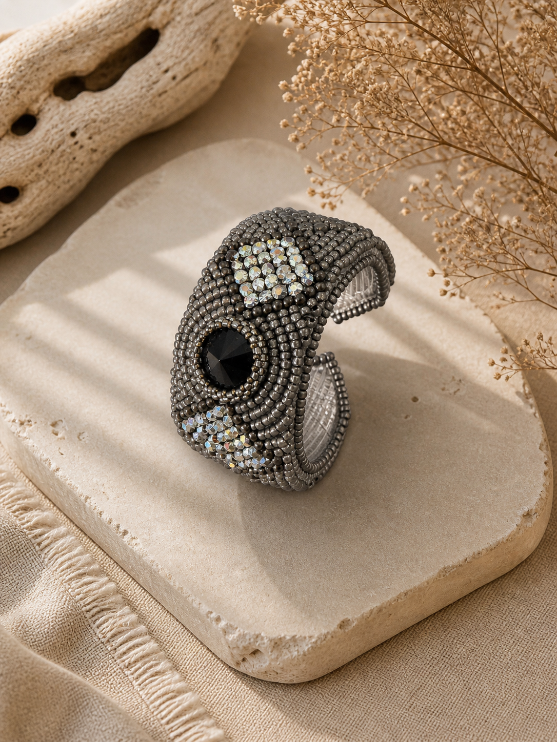 Gunmetal bead embroidered cuff bracelet with black crystal centerpiece and shimmering silver crystal accents.