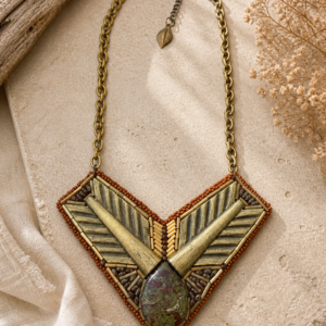 Geometric bead embroidered necklace with dragon blood stone focal, brass chain, and earthy bronze beadwork.