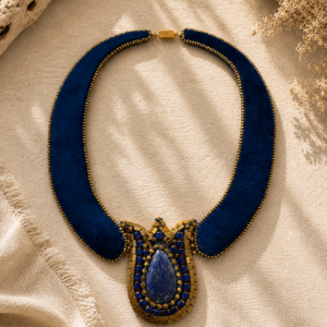 Velvet statement collar necklace in deep cobalt blue with gold bead embroidery and a lapis stone focal pendant.