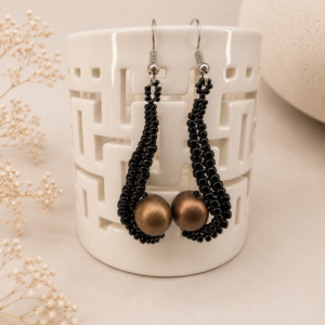 Handwoven black seed bead earrings featuring elongated teardrop shapes with matte bronze round focal beads and sterling silver ear wires.
