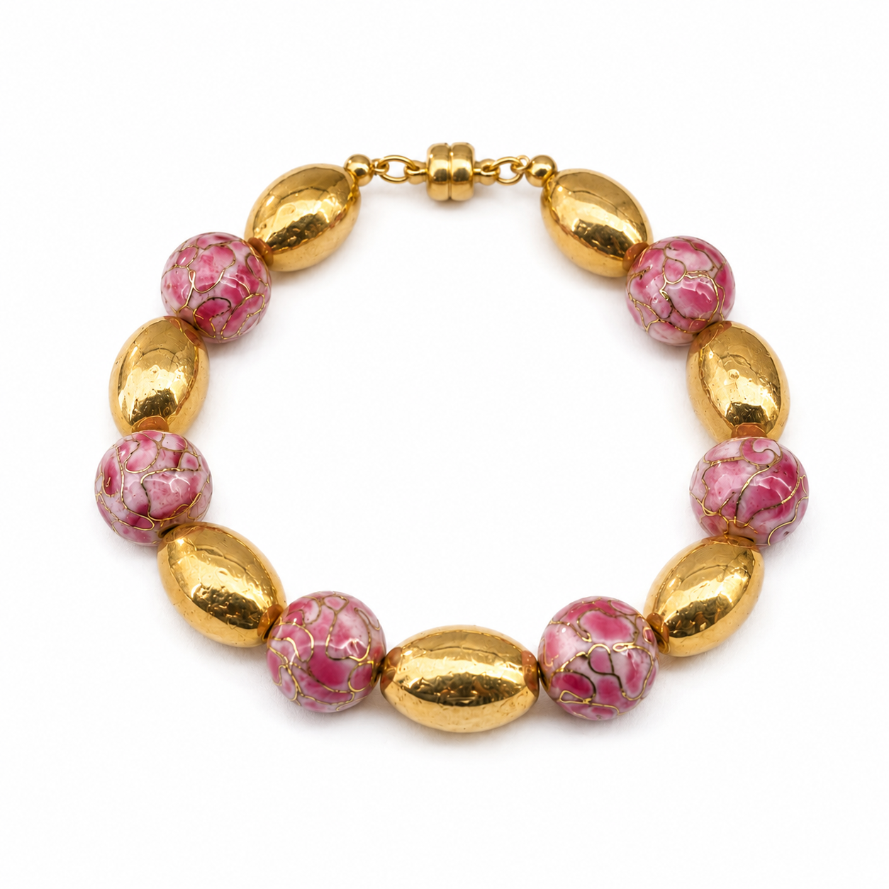 Handcrafted bracelet featuring pink artisan beads with gold veining, large gold-toned oval beads, and a gold-toned magnetic clasp arranged in an alternating pattern.