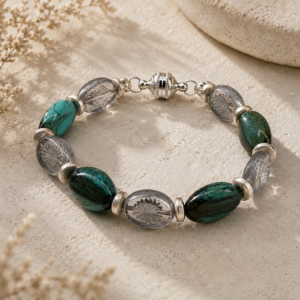 Handcrafted bracelet featuring marbled teal glass beads, translucent etched glass beads, sterling silver accents, and a decorative magnetic clasp.