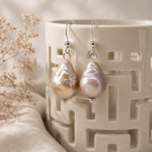 Pair of blush pink baroque freshwater pearl earrings suspended from sterling silver ear wires,