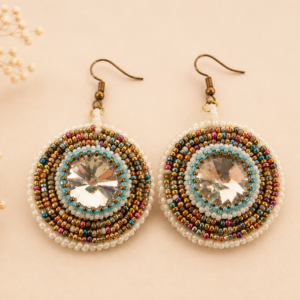 Handcrafted bead embroidered earrings featuring large crystal rivolis surrounded by concentric rings of white, aqua, gold, bronze, teal, and berry seed beads.