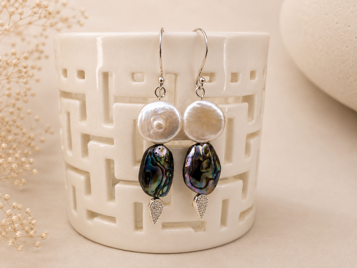 Handcrafted earrings featuring large freshwater coin pearls, iridescent abalone shell beads, pavé crystal accents, and sterling silver ear wires.